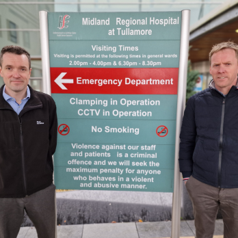 Mildlands Regional Hospital at Tullamore Sign with a Bord na Móna Recycling Rep and Manager of the hospital either side